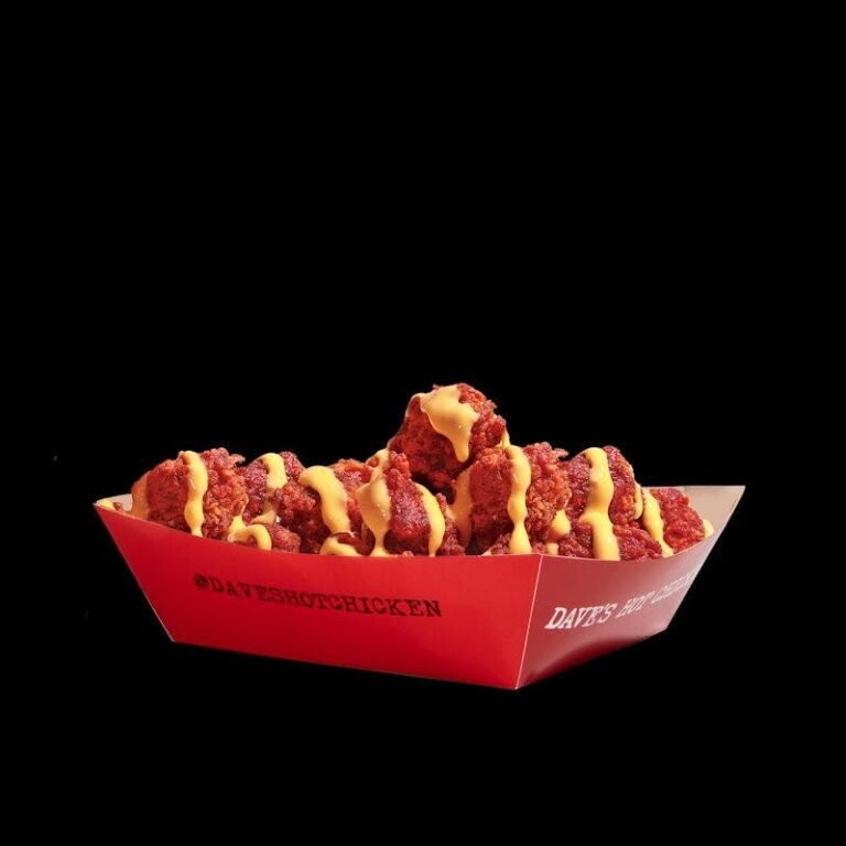 Dave’s Hot Chicken Cheesy Bites covered in cheese sauce