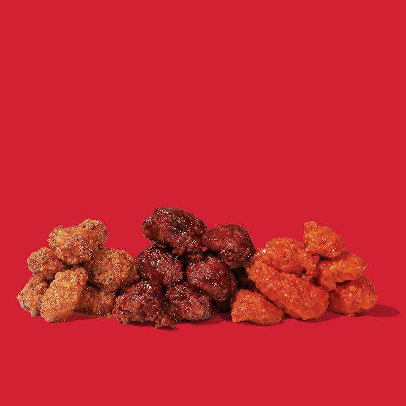 Dave’s Hot Chicken Flight of Saucy Bites with multiple sauce flavors