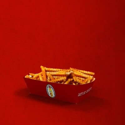 Dave’s Hot Chicken regular seasoned crinkle-cut fries in a red tray