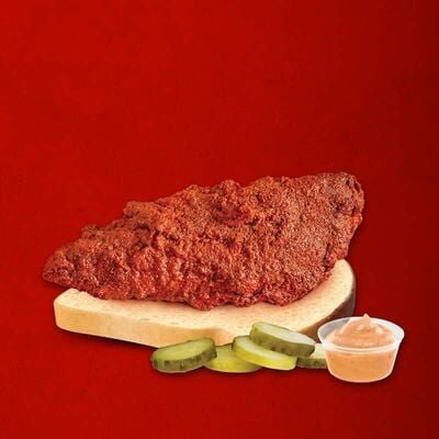 Dave’s Hot Chicken single tender on sliced bread with pickles and Dave’s Sauce