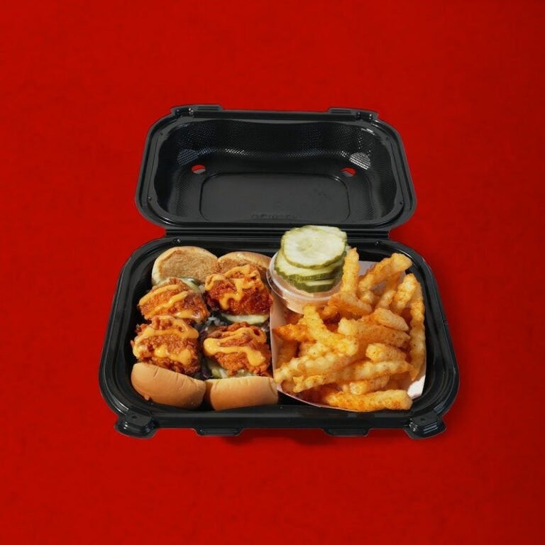 Four Dave’s Hot Chicken mini sliders served with crinkle-cut fries