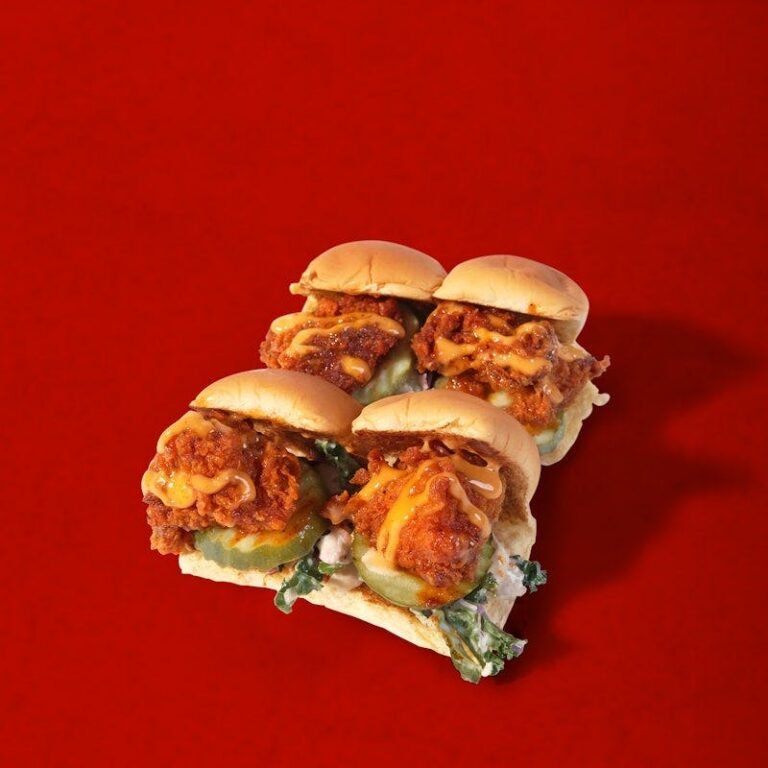 Four Dave’s Hot Chicken mini sliders with kale slaw